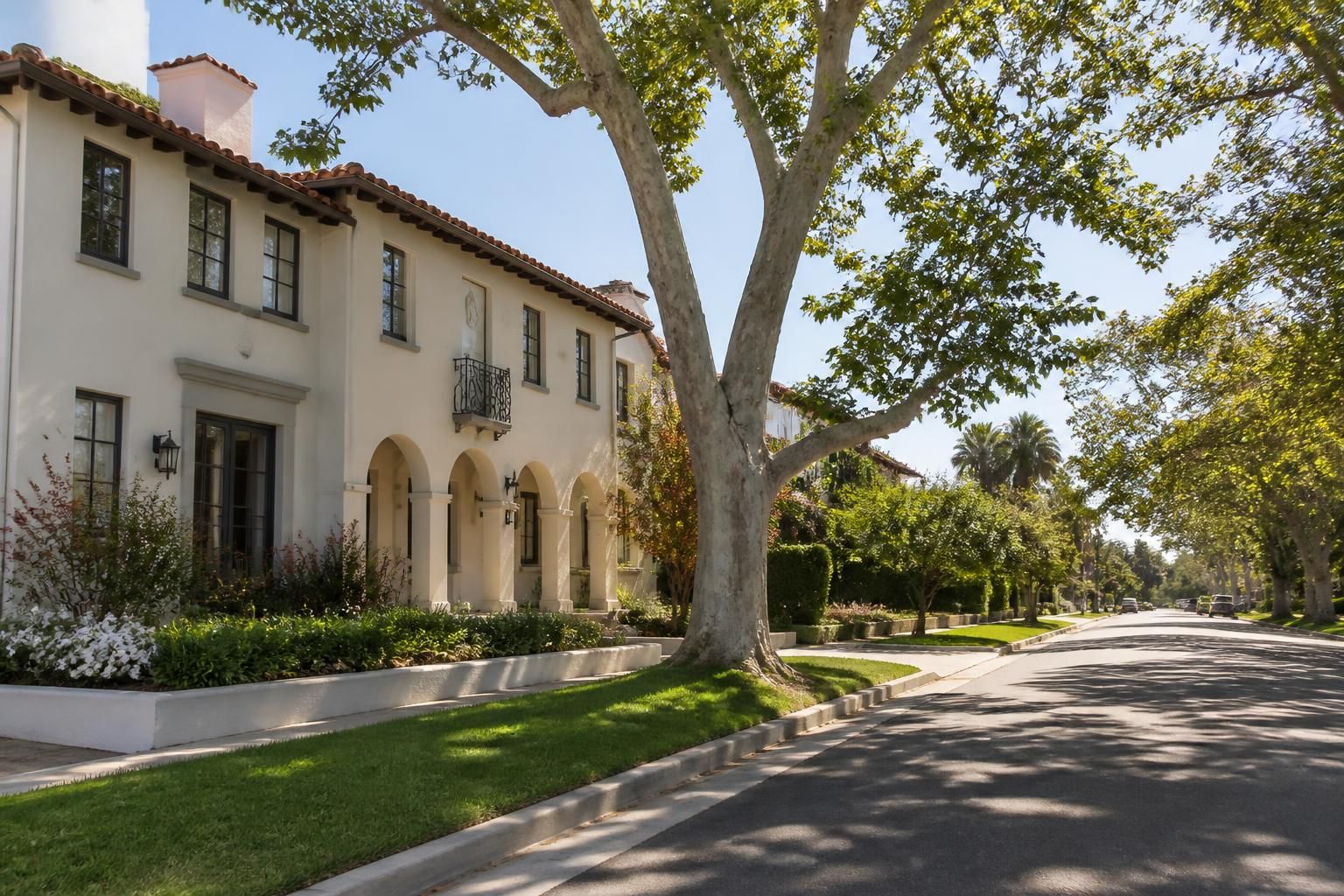 Tree-lined Pasadena neighborhood with elegant historic architecture.